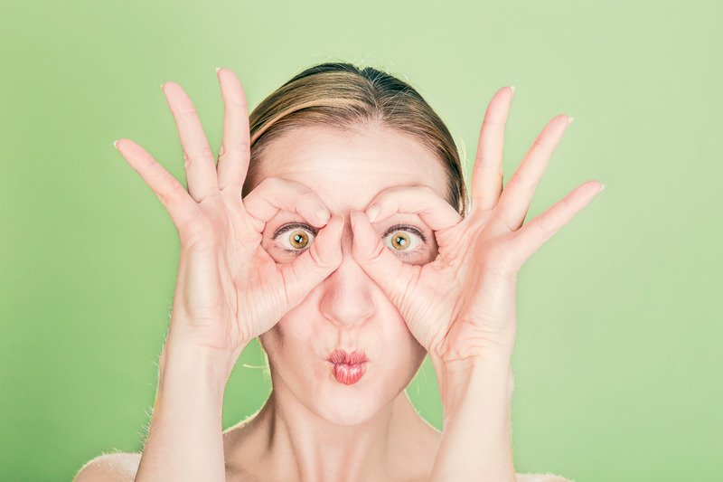 woman doing goggles hands gesture