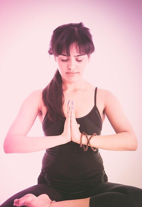 a woman is sitting doing Meditation