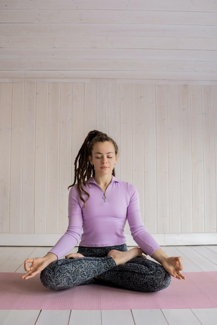 a young woman is practicing meditation