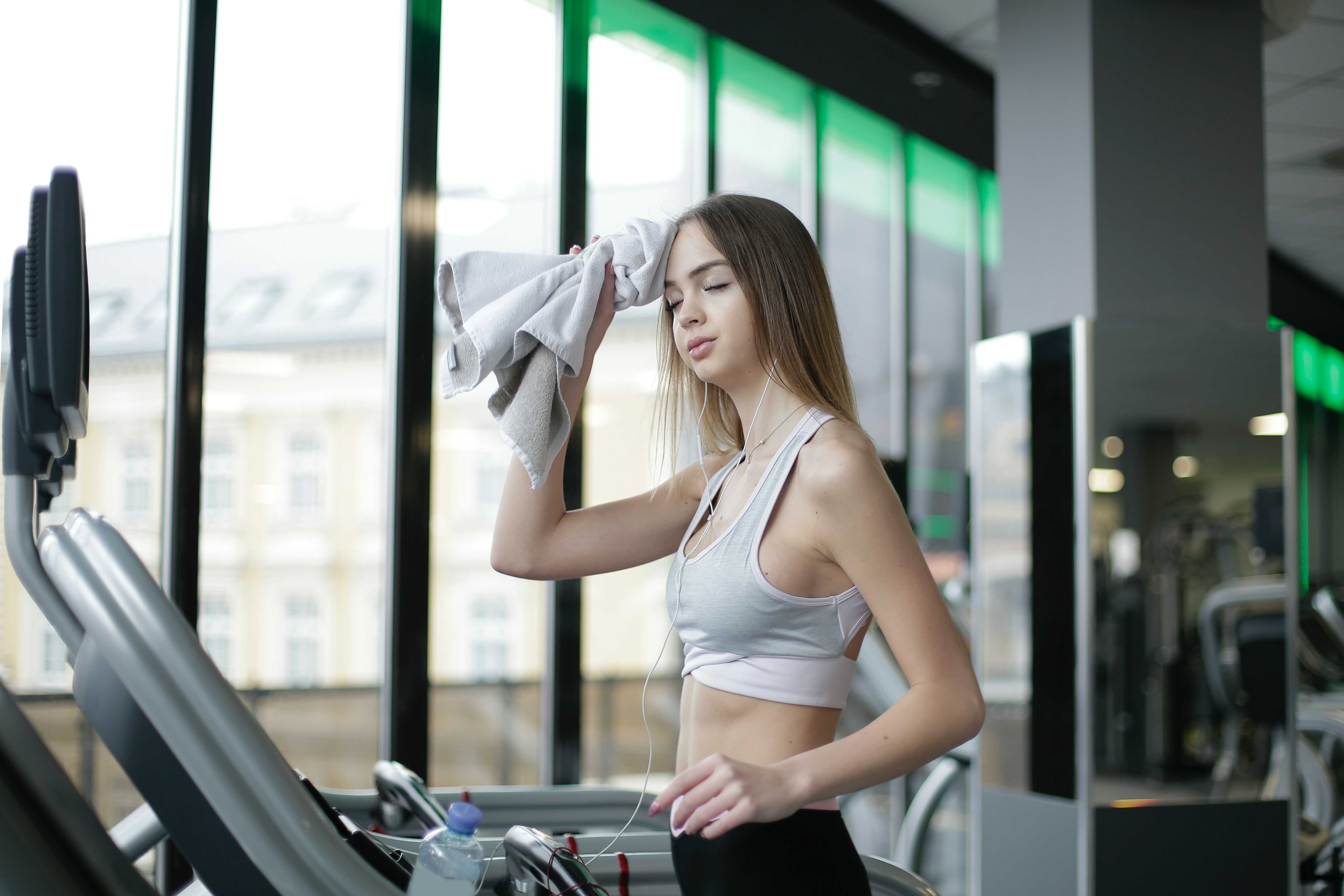 a woman in the gym swapping her sweat