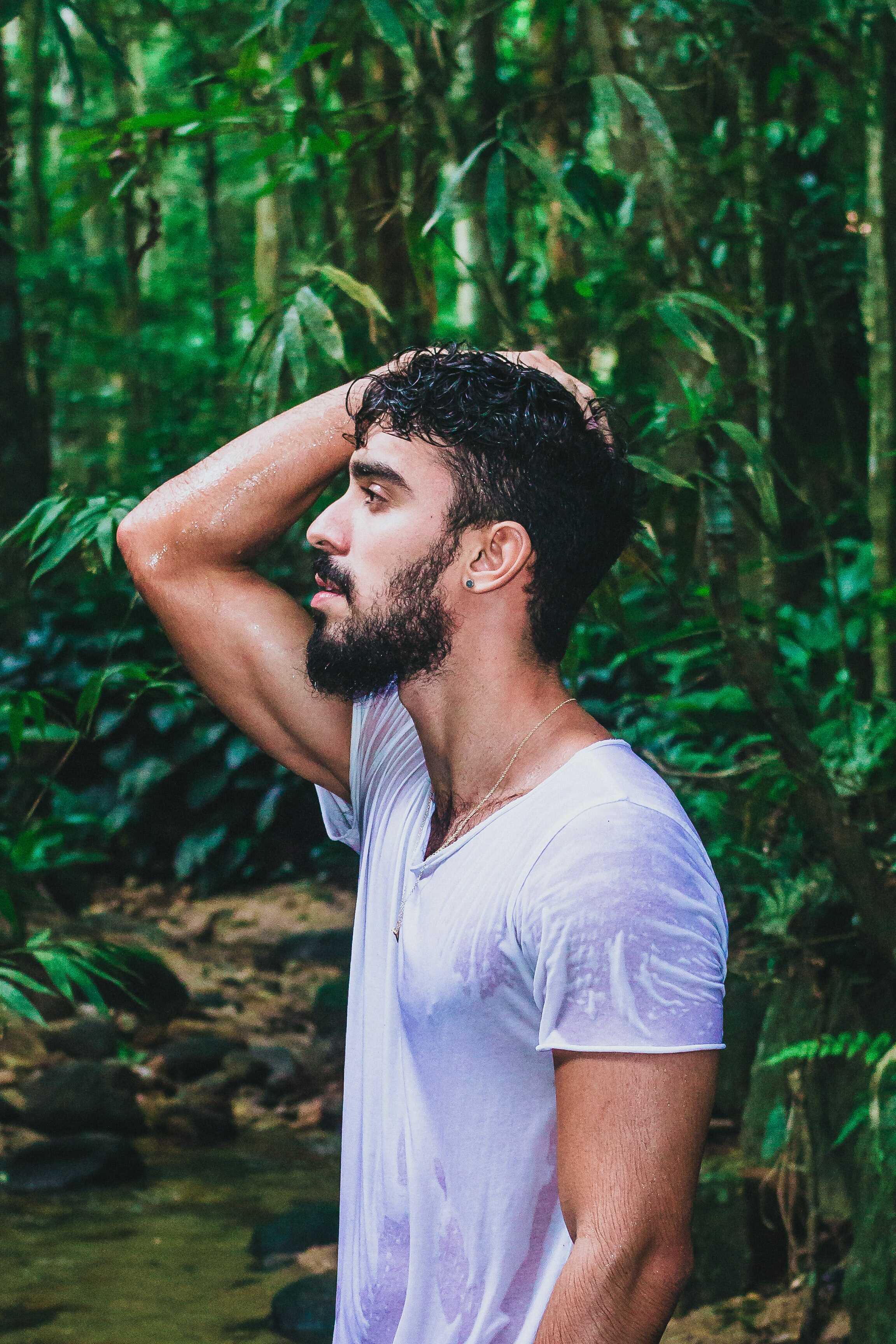 an athlete is sweating heavily on his white shirt