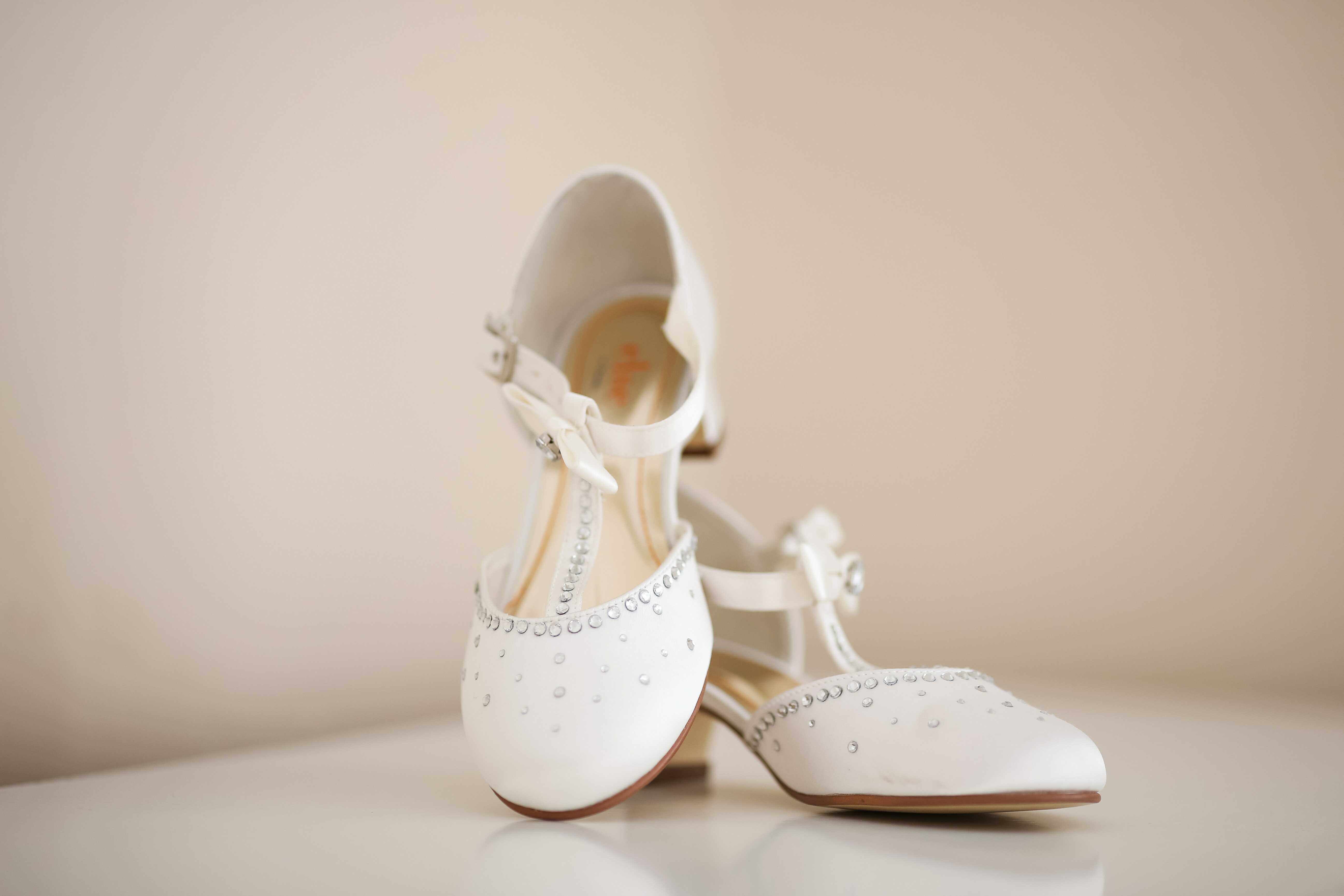 a white t-shaped strap heels