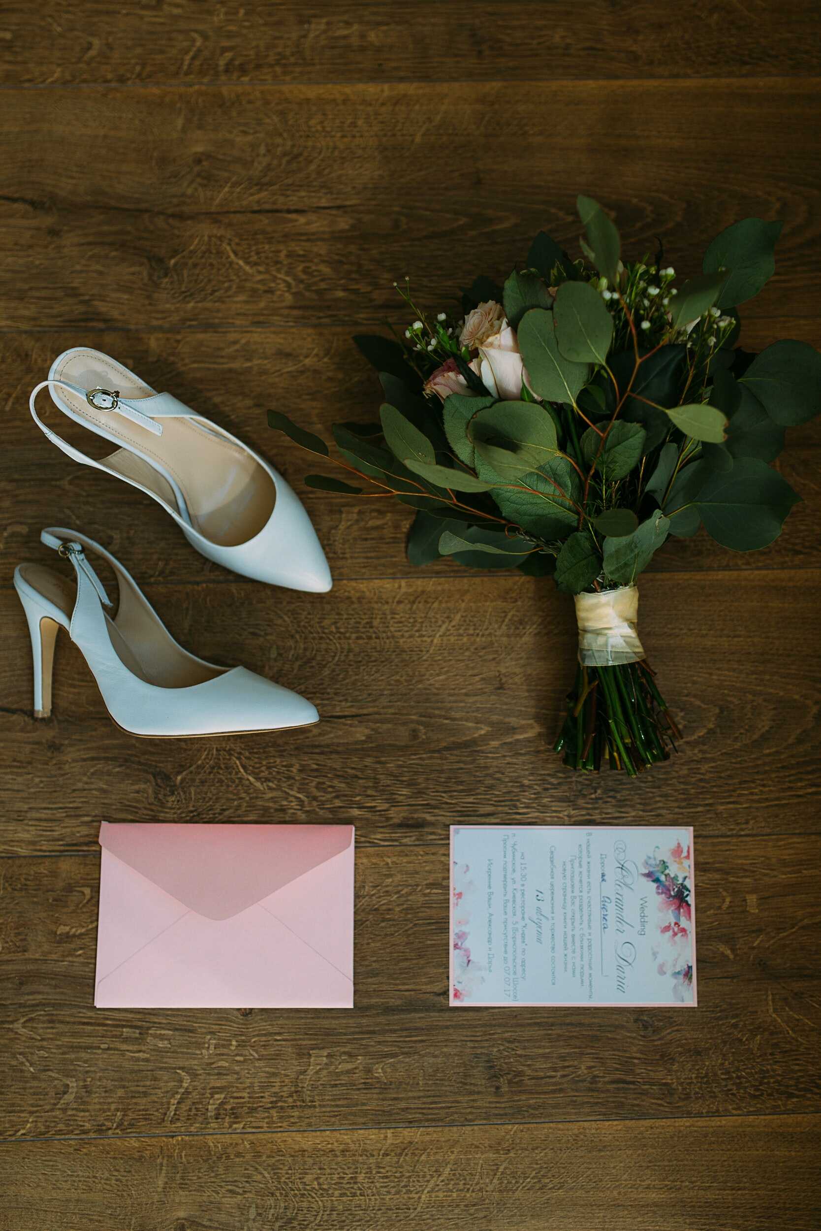 a white sling back heels with flower bouquet and a letter