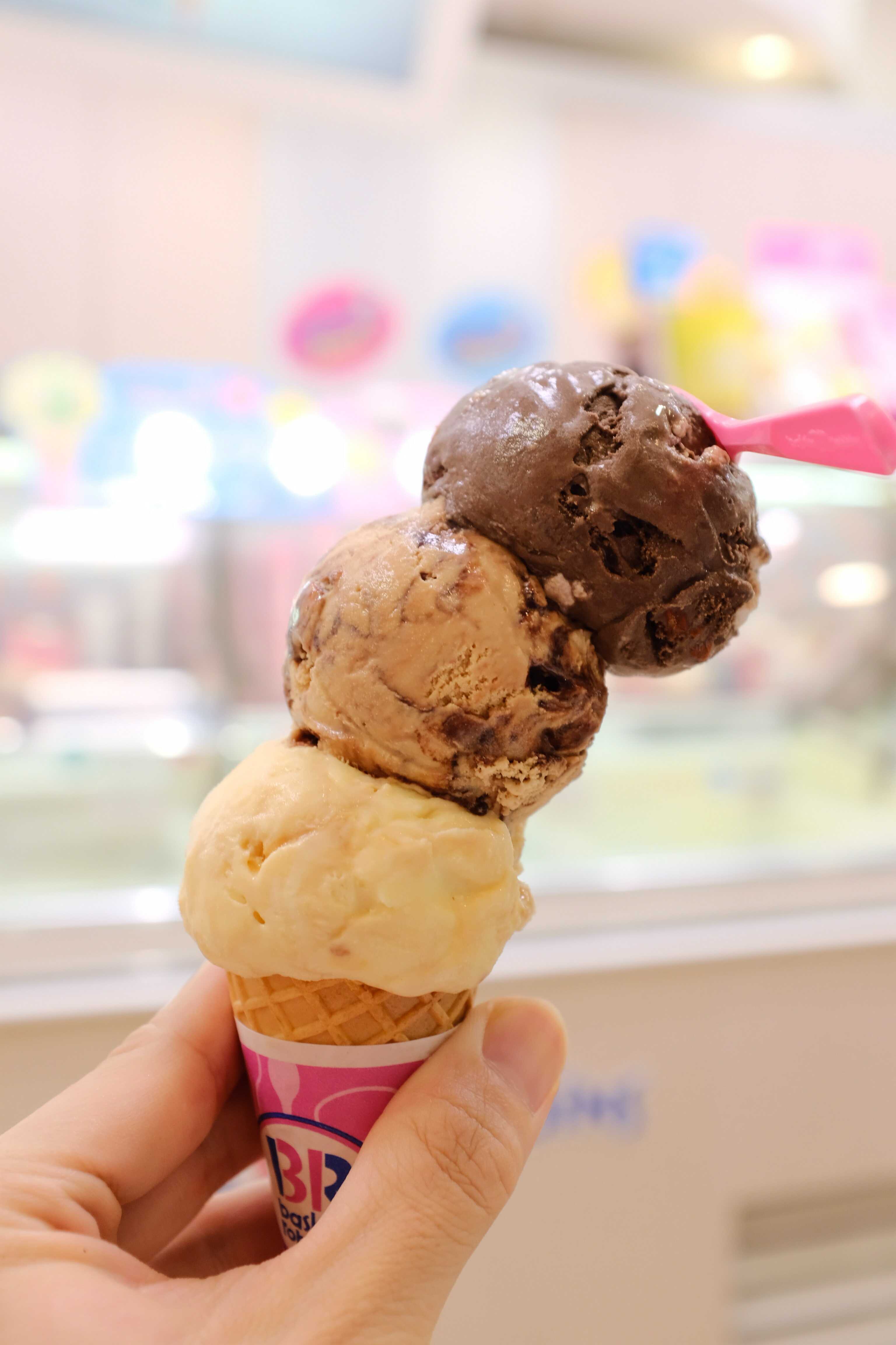 a three ice cream balls on a cone